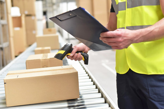 workers in the warehouse scanning parcels for retail and transport shipping