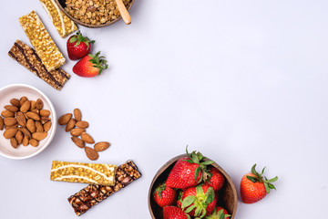 Coconut Bowls with Granola or Muesli with Wooden Spoon Bowl with Ripe Strawberry and Almond Green Apple Muesli Bars Blue Background Healthy Diet Breakfast Top View Copy Space