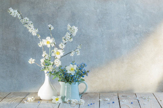 Spring  Flowers In  Vases  On Background Old  Wall