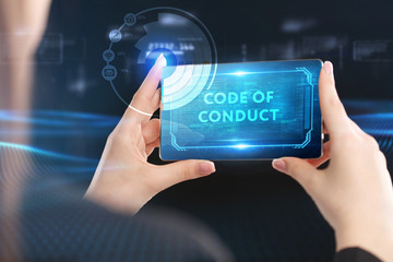 Business, Technology, Internet and network concept. Young businessman working on a virtual screen of the future and sees the inscription: Code of conduct