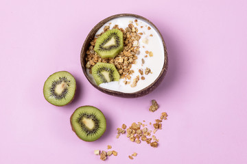Coconut Bowl With Fresh Kiwi and Granola or Muesli Bowl of Homemade Granola for Healthy Breakfast Diet Food