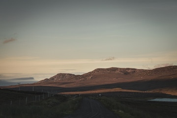 Rural Road Across Scottish Highlands at Sunset