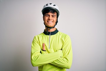 Young handsome cyclist man wearing security bike helmet over isolated white background happy face smiling with crossed arms looking at the camera. Positive person.