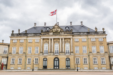 Fototapeta na wymiar Classical palace facades with rococo interiors of the Amalienborg, the home of the Danish royal family, and is located in Copenhagen, Denmark.