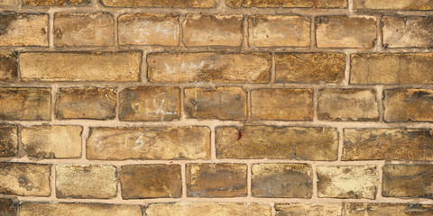 Panoramic view of the aged yellow brick wall.