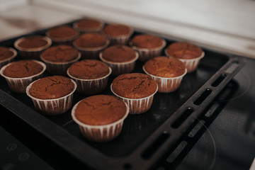 Chocolate muffins bakery. Brownie cupcakes on the baking pan. Baking at home, home bakery.