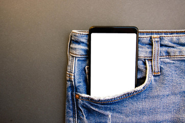 White screen smartphone in jeans pocket. Smartphone place for text. Smartphone in a pocket on a black background.  Copy Space