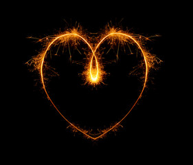 heart, written with a sparkler on a black background