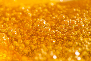 Liquid yellow paste for sugaring close-up. Depilation and hair removal concept. Macro photography.