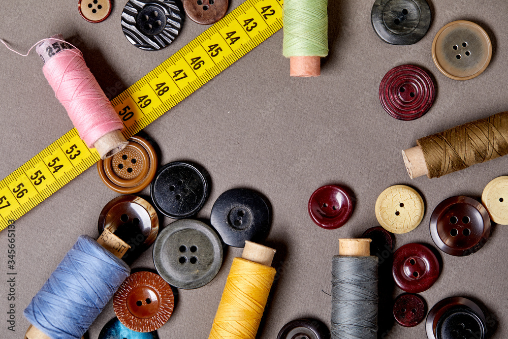 Poster background and texture of multicolored antique buttons and sewing tools