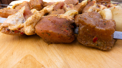 marinated pork skewers on skewers with spices and onions. raw meat in chunks