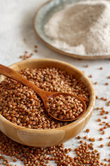 Buckwheat gran and flour in bowls with a spoon