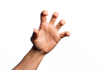 Hand of caucasian young man showing fingers over isolated white background grasping aggressive and...