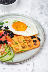 potato savory waffles with salmon, egg and caviar