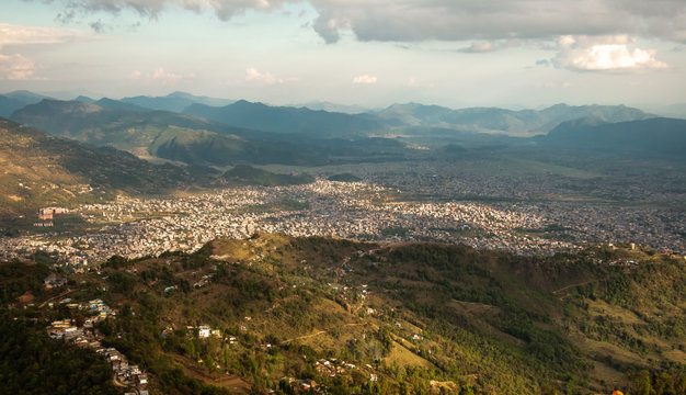 An aerial view of the city of Pokhara in Nepal and the hills surrounding the city.