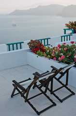 Two armchairs on a balcony on Santorini in Greece.