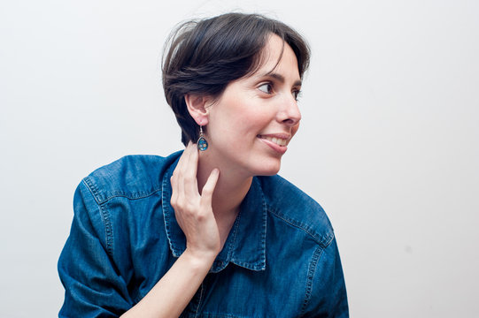 profile view of a young woman with short hair wearing blue jeans. Great copy space.