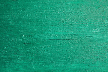 Fototapeta na wymiar Texture of old wooden board covered in green paint. Horizontal board