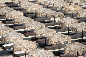 Beach umbrellas on an empty beach. Closed season 2020. 