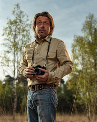Nature photographer in nature reserve at sunrise during spring.