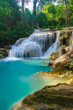 The beautiful Erawan cascade waterfall with turquoise water like heaven at the tropical forest ,Kanchanaburi Nation Park, Thailand © Anukool