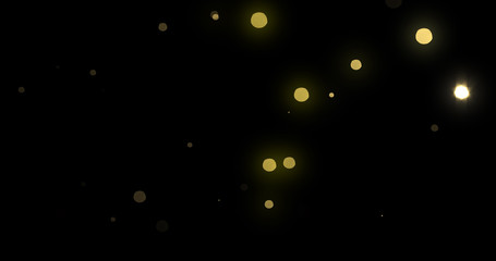 Bokeh light gold shine background with abstract blur flare effects. Golden yellow glitter particle flares with bright glowing shiny light bokeh sparkles on black background