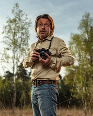 Nature photographer in nature reserve at sunrise during spring.