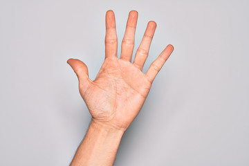 Hand of caucasian young man showing fingers over isolated white background counting number 5 showing five fingers