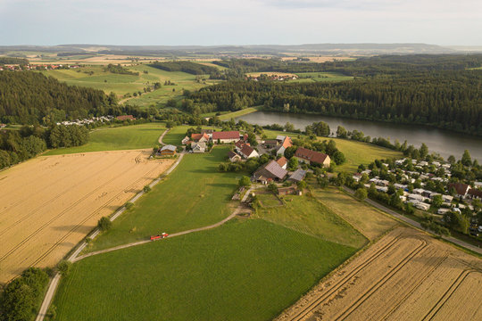 Aerial view of tractor driving to farm in Haselbach