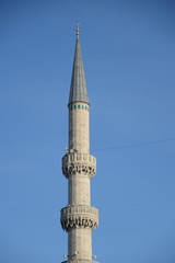 Minaret in Turkish Istanbul on a background of blue sky