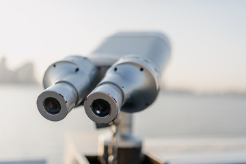 telescope with city skyline