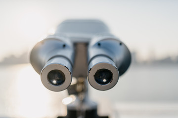 telescope with city skyline