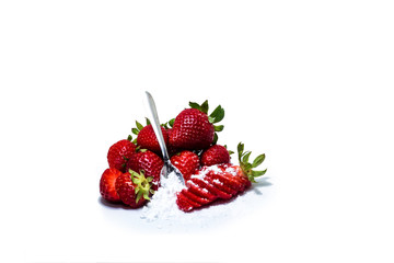 Closeup of fresh strawberries and sugar isolated on white background.