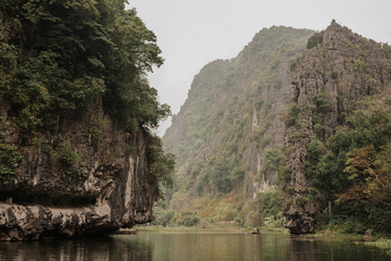 Fototapeta na wymiar Landscape of Karst formation in the water along the Ngo Dong River at the Tam Coc National Park, Ninh Binh Province, Vietnam. Most spectacular scenery in Vietnam's.