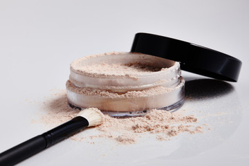 Foundation Powder and Brush in a Circular Container.