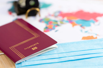 Travel concept, passport and mask on a map with blurred background. Covid 19. Coronavirus