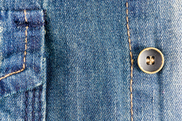 clothing items blue stonewashed faded jeans cotton fabric texture with seams, clasps, buttons and rivets, macro, close-up