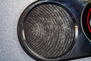 Extreme closeup of cellphone fingerprint reader with fingerprint