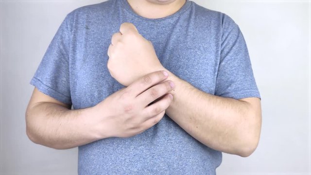 A man suffers from elbow pain. Damaged elbow joint, bone fracture, or sprain. Hand injury and flexion pain concept