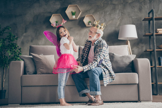 Profile photo of funny aged old grandpa golden crown head little pretty granddaughter fairy prepared stage costumes performers stay home quarantine safety modern interior living room indoors