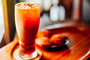 Iced coffee americano in a glass on wood table  in coffee shop.