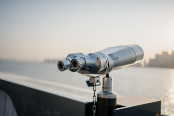 telescope with city skyline