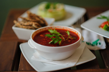 Vegan borscht in bowls on an old wooden background