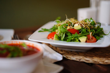Vegetarian salad with sprouts on an old wooden table.