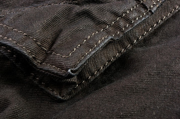 clothing items stonewashed cotton fabric texture with seams, clasps, buttons and rivets, macro