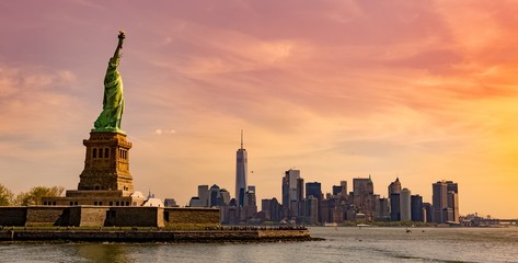 Picture of a statue of liberty national monument under the mesmerizing sunset