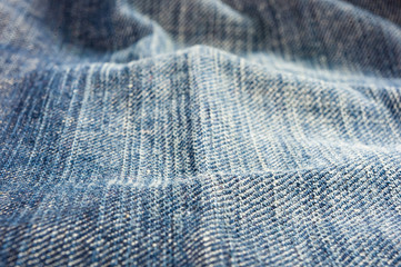 clothing items blue stonewashed faded jeans cotton fabric texture with seams, clasps, buttons and...