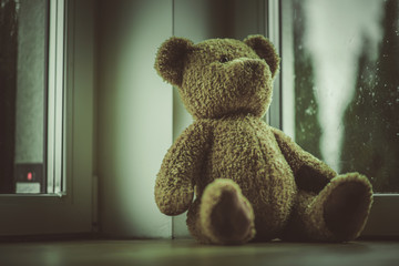 Close Up Of Teddy Bear Toy Placed By Window In Bedroom.