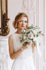 Portrait of the bride. Young girl, blonde with a short haircut. Close-up, vintage. Beautifully poses