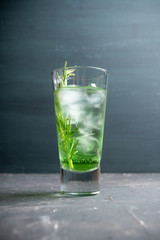 Sweet tequila based green cocktail with tarragon and rosemary. Selective focus. Shallow depth of field.